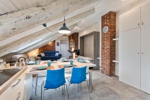 a kitchen and living room with a table and chairs at ACADAMIS - Loft dei Principini in Turin