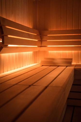 an empty sauna with wooden floors and lights at Fahrenheit Seven Val Thorens in Val Thorens