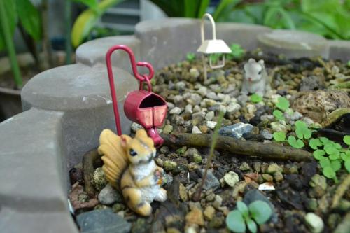 a toy bear holding an umbrella in a rock garden at AMAMI-Green-Garden in Amami