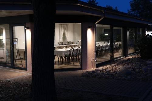 a restaurant with tables and chairs in the windows at Radduscher Hafen in Vetschau