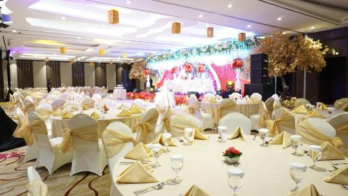 a banquet hall with white tables and chairs at Crowne Plaza Bandung by IHG in Bandung
