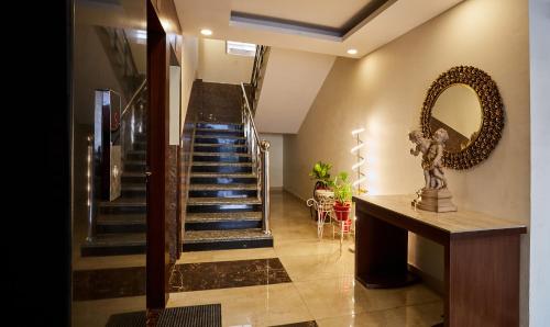 a hallway with a spiral staircase with blue steps at Treebo Grand Legacy Elite With Roof Top Cafe in Dehradun