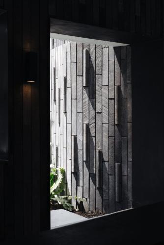 a window with a view of a building at Lloyd's Inn Bali in Seminyak