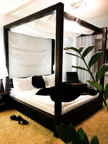 a bedroom with a bed with a black frame at SPA Hotel in Vorzelʼ