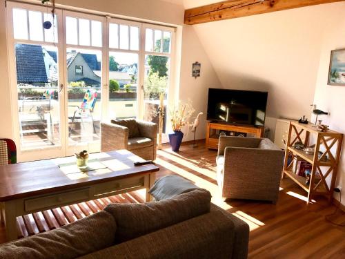 a living room with a couch and a table at Haus Jui in Zingst