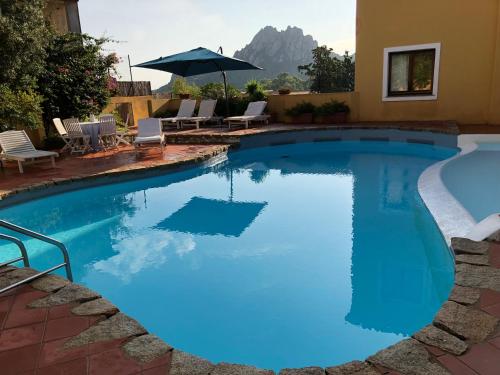 a large swimming pool with blue water at Boutique Hotel Sant'Andrea & Relais in San Pantaleo