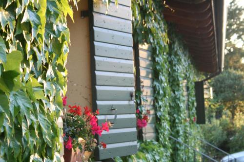 a house with flowers on the side of it at Corte San Mattia in Verona