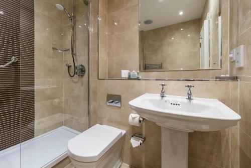 a bathroom with a sink and a toilet and a shower at Macdonald Inchyra Hotel & Spa in Falkirk