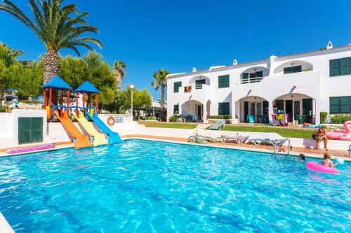 a pool with a slide and a playground at Playa Parc Apartments in Son Parc