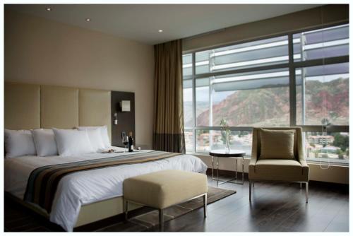 a bedroom with a bed and a large window at Casa Grande Hotel in La Paz