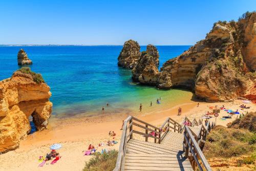 a view of a beach with people in the water at Casa dos Ninos in São Bartolomeu de Messines