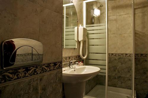 a bathroom with a sink and a shower at Luxor Hotel in Smolyan