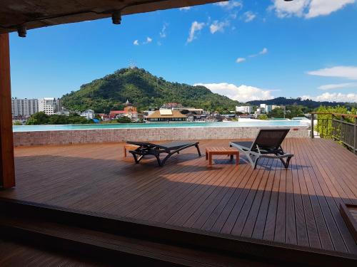 a wooden bench sitting on top of a sandy beach at EcoLoft Hotel - SHA Plus in Phuket