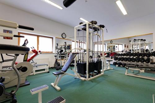 a gym with a lot of equipment in a room at Hotel Römerhof in Fusch an der Glocknerstraße