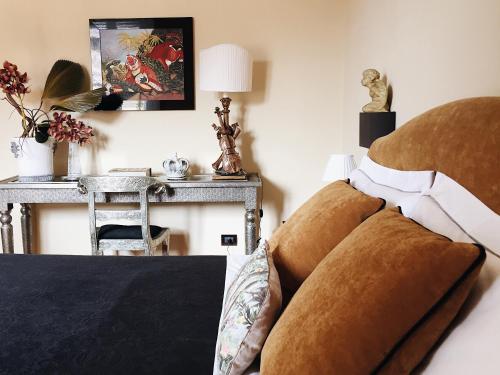 a bedroom with a bed with pillows and a table at Casa Roma Luxury Apartment in Rome