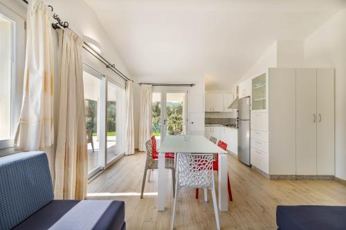 a kitchen and dining room with a table and chairs at Ville D'Ogliastra in Cardedu