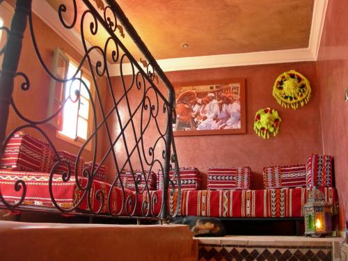 a room with a red couch in a restaurant at Riad-villa Agadir-Taroudant in Sidi Boumoussa