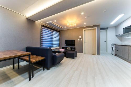 a living room with a couch and a table at It's W in Suwon