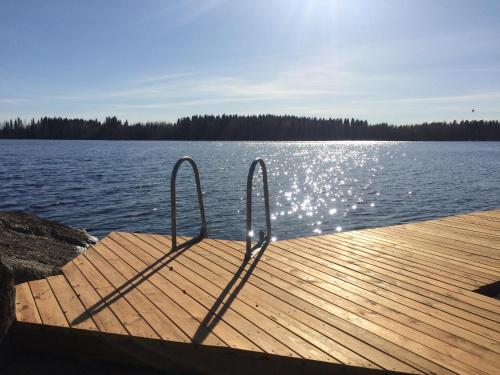 a dock with two metal rails on a lake at Hyvölän Mökit in Ähtäri