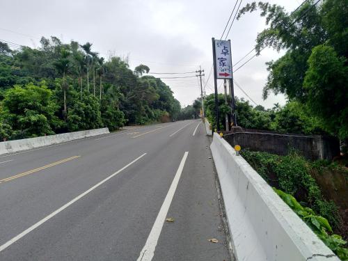 an empty road with a sign on the side at Juo House in Fanlu