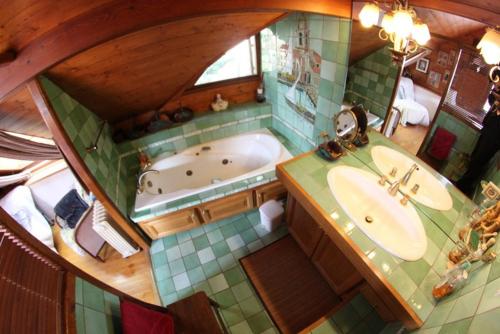 an overhead view of a bathroom with a tub and sink at Les Tanneries in Villar-Saint-Pancrace