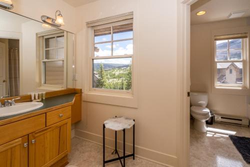 a bathroom with a sink and a toilet and a window at Saddle Ridge I2 in Big Sky