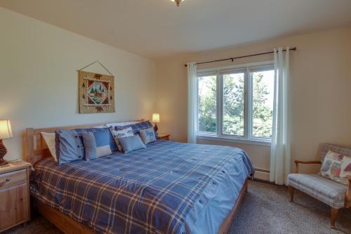 a bedroom with a bed and a chair and a window at Cottage of Course - Permit #3092 in Estes Park