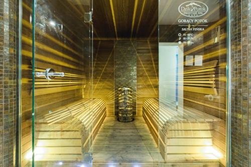 a sauna in a building with a glass door at Dziki Potok Konferencje Grill & Prestige SPA in Karpacz
