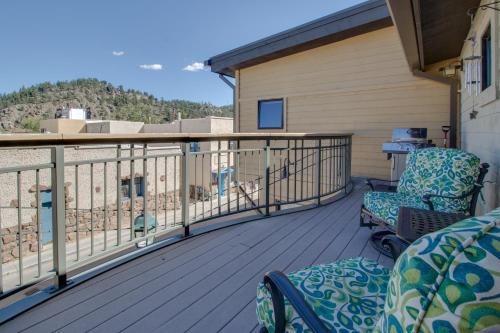 a balcony with two chairs on a house at Spacious Dtwn Estes Park Loft Condo 4 Mi to RMNP in Estes Park