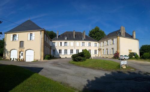 a large house with a car parked in front of it at Maison d'hôtes Le Château de Puxe in Puxe