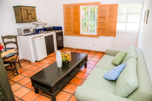 a living room with a couch and a table at Los Milagros Hotel in Cabo San Lucas