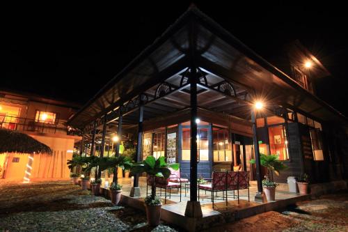 a house with plants in front of it at night at Argovia Ecolodge in Tapachula