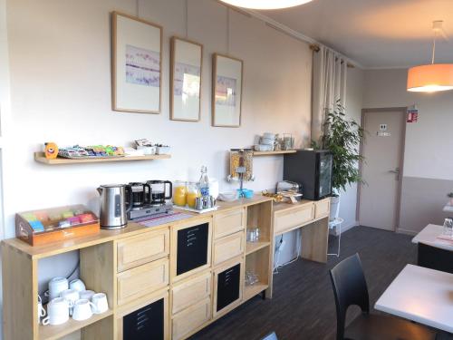 Habitación con cocina con barra y TV. en Les Lavandes, en La Ciotat