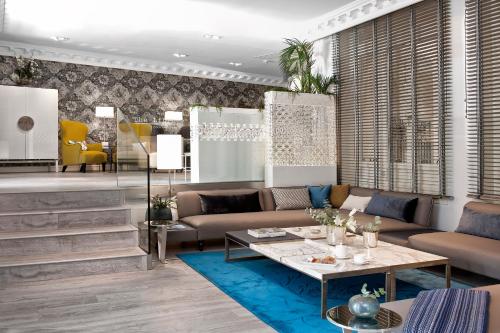 a living room with a couch and a table at Hotel Sardinero Madrid in Madrid
