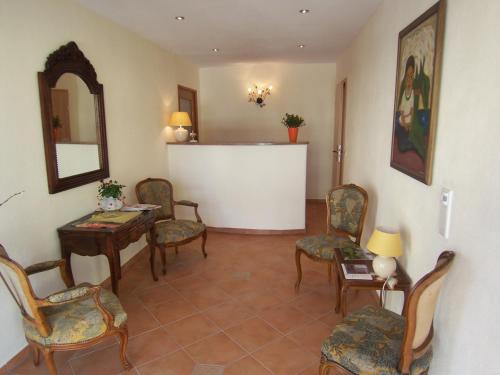 a living room with chairs and a table and a mirror at Gästehaus Casa Cristina in Bad Krozingen