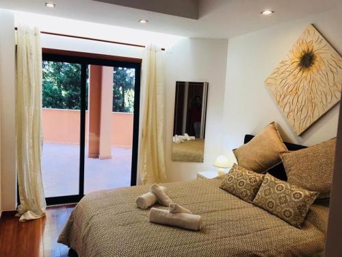 a bedroom with a large bed with a large window at Rother Praia da Luz Luxury Apartment in Luz