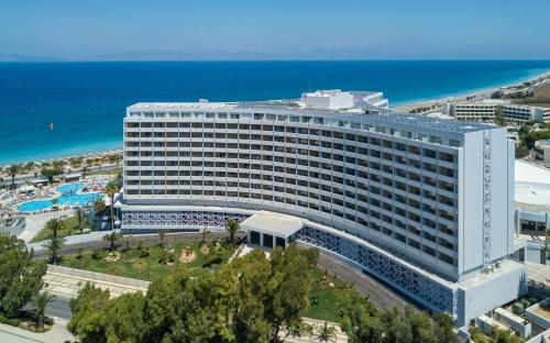 a large white building next to the ocean at Akti Imperial Deluxe Resort & Spa Dolce by Wyndham in Ixia