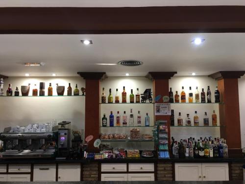 a bar with a lot of bottles on the wall at Hotel La Parra in Cuevas del Almanzora