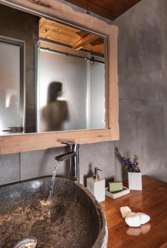 a bathroom with a sink and a mirror at Redstone Luxury Villas in Theológos