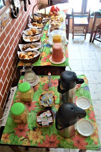 a long table filled with food on a table at Pousada do Imperador in Paraty