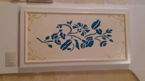 a blue and white painting on a wall at Dimora d'epoca "Ideale per Coppie" in Avola