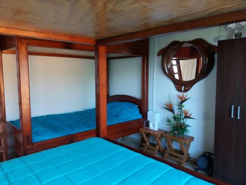 a bedroom with two bunk beds and a mirror at Casa Estela del Mar in Pelluhue