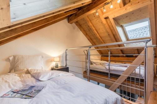 a bedroom with a bunk bed in a attic at Les Edelweiss Mont-Blanc - Gîte Classé 3 Etoiles in Passy