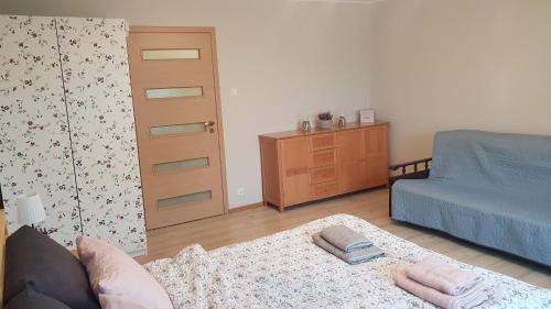 a living room with a couch and a bed at Guzikowa Chata in Dobczyce