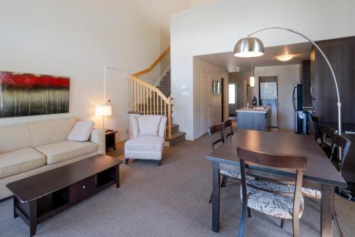 a living room with a couch and a table at Condos Château-Bromont in Bromont