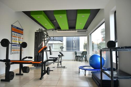 a gym with treadmills and weights in a room at Convair Hotel in Ciudad del Este