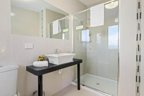 a bathroom with a sink and a shower at Manfield Seaside Bruny Island in Alonnah