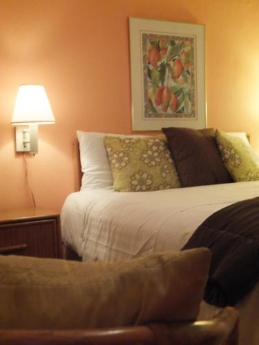 a bedroom with a bed and a table with a lamp at Canario Boutique Hotel in San Juan