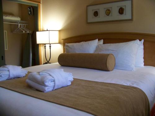 two towels on a bed in a hotel room at The Pines at Sunriver in Sunriver