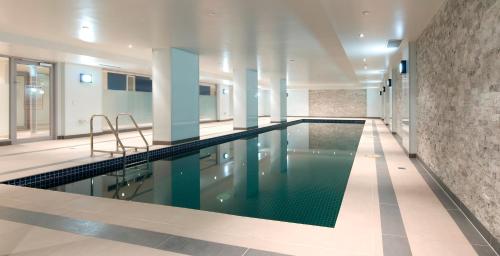 a large swimming pool in a building with a pool at Atlantis Hotel Melbourne in Melbourne